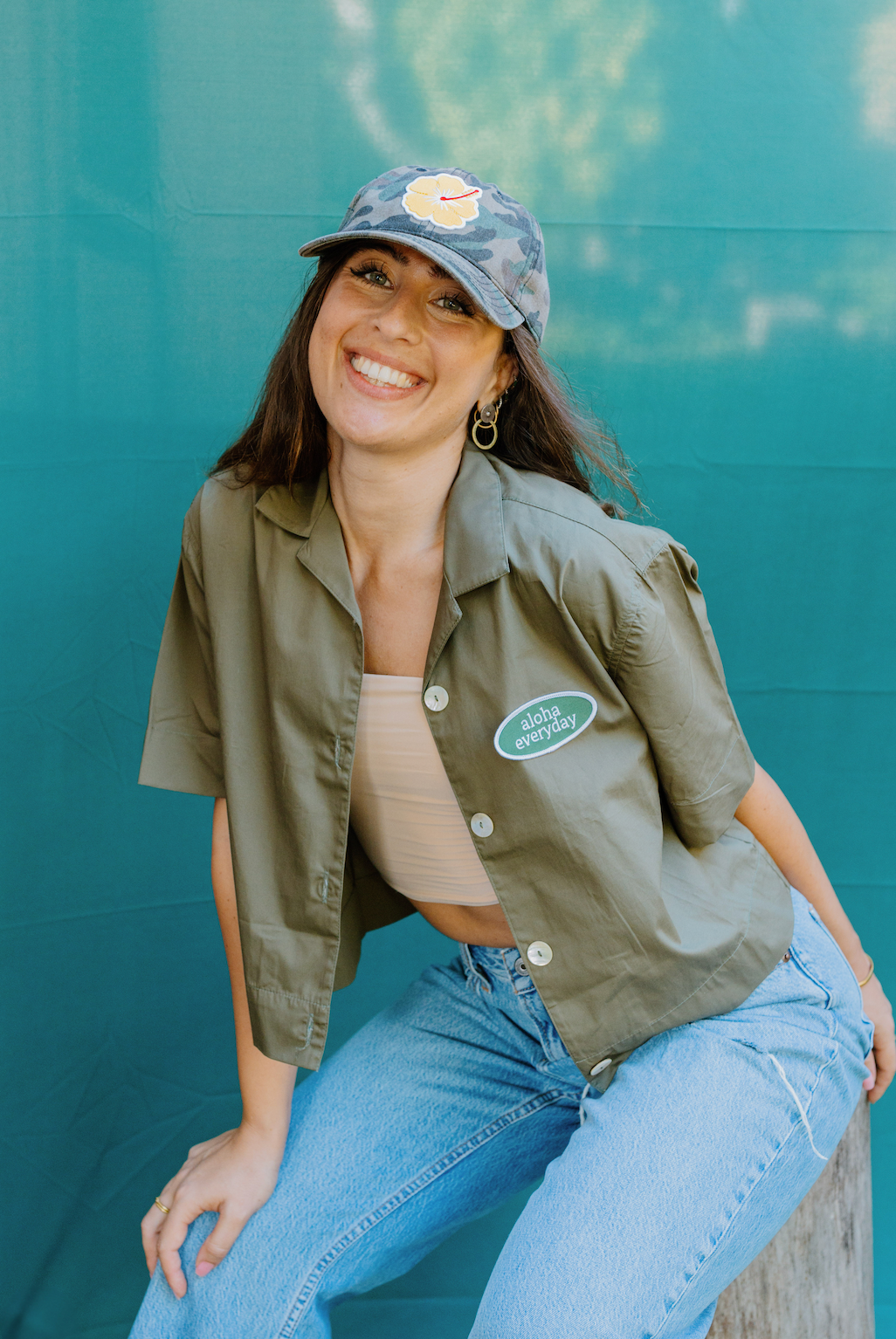 "Women wearing custom yellow hibiscus camouflage baseball cap with adjustable fit, perfect for outdoor casual wear."