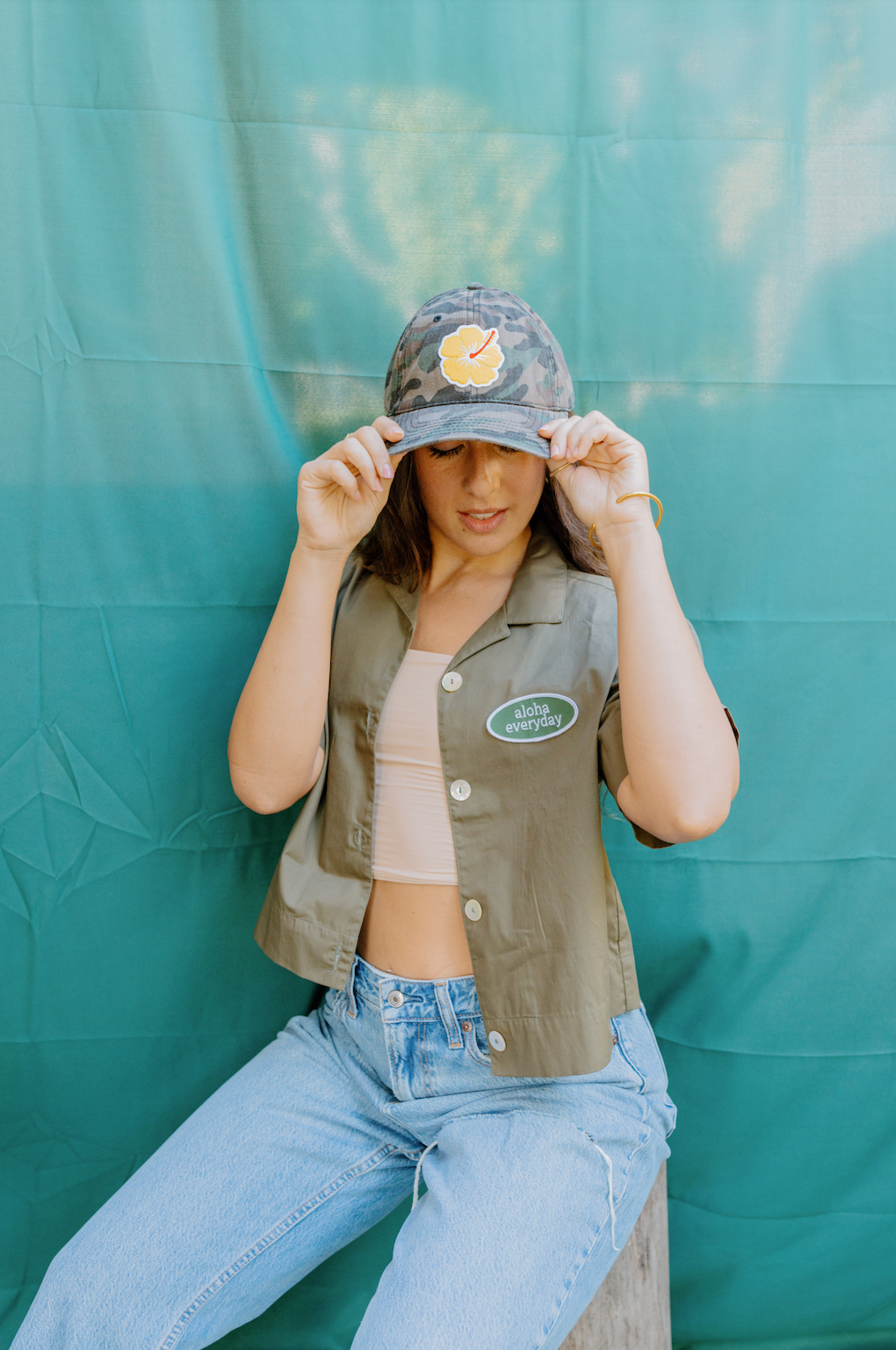 "Women wearing custom yellow hibiscus camouflage baseball cap with adjustable fit, perfect for outdoor casual wear."