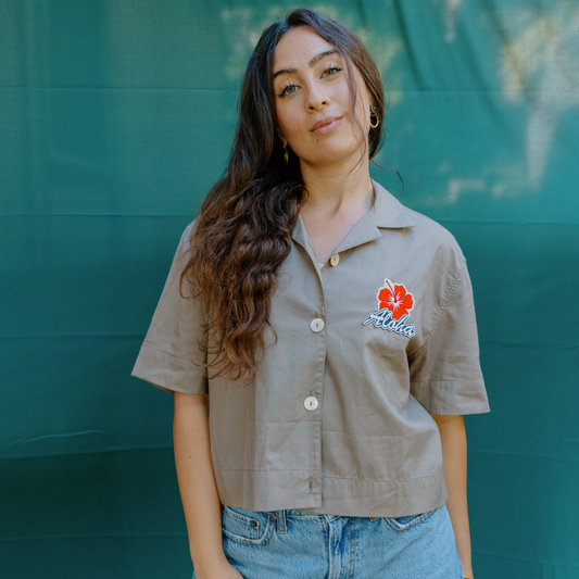 “Upcycled women’s button-up shirt with ‘Aloha’ and Hibiscus patches by The Patch Bar Hawaii, showcasing relaxed fit and sustainable design.”