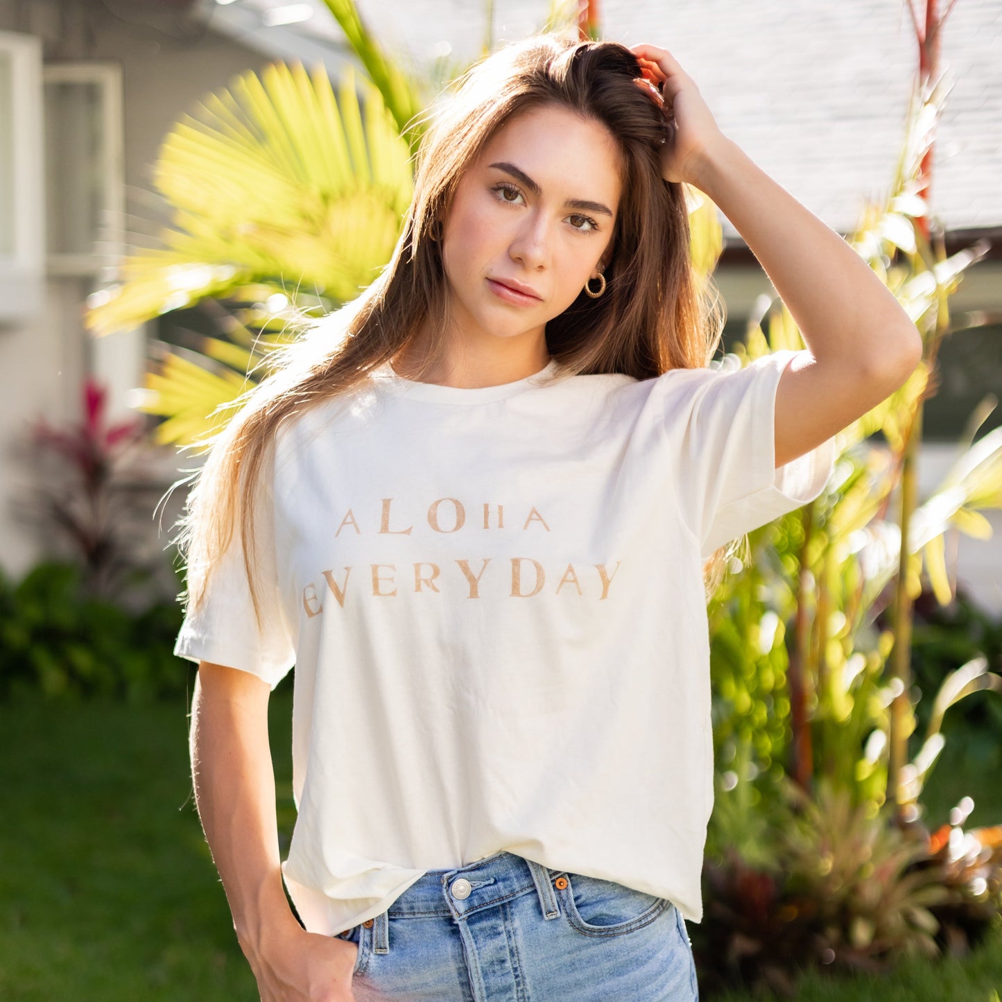 Can you really ever have enough comfy tees? We don't think so. Our white tees are made with organic cotton. Featuring a hand stamped lettering unique to each tee. This shirt is completely plant based and safe on your skin and our planet. This tee comes pre-cut at the hem for the perfect length, hitting right at your waistline. Pre-washed for ultimate comfort and added softness.  Hand Stamped  Perfect for high-waisted bottoms, can be tucked in  Raw Hemline, Relaxed Fit  Model is wearing size medium