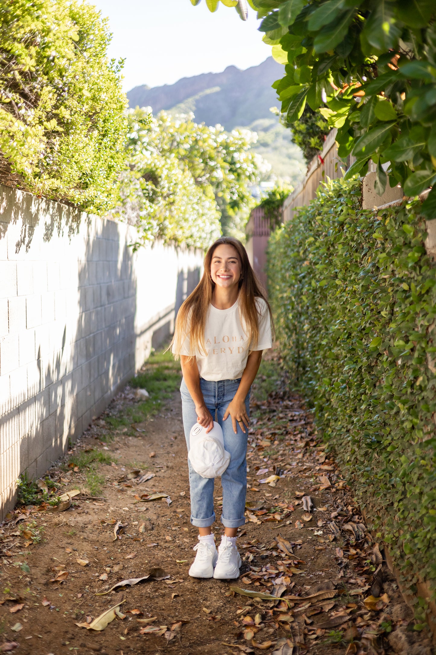Can you really ever have enough comfy tees? We don't think so. Our white tees are made with organic cotton. Featuring a hand stamped lettering unique to each tee. This shirt is completely plant based and safe on your skin and our planet. This tee comes pre-cut at the hem for the perfect length, hitting right at your waistline. Pre-washed for ultimate comfort and added softness.  Hand Stamped  Perfect for high-waisted bottoms, can be tucked in  Raw Hemline, Relaxed Fit  Model is wearing size medium