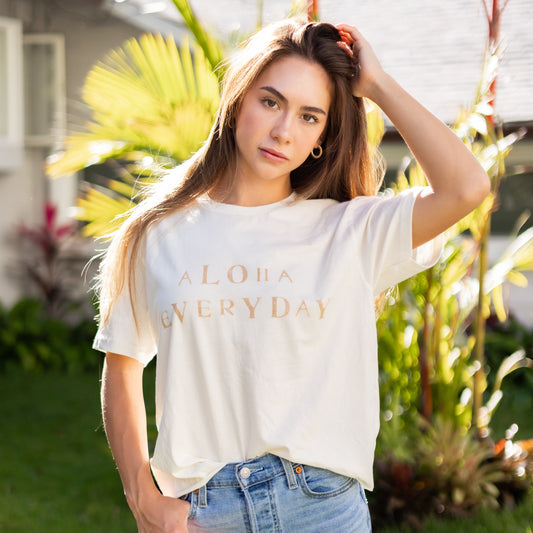 Can you really ever have enough comfy tees? We don't think so. Our white tees are made with organic cotton. Featuring a hand stamped lettering unique to each tee. This shirt is completely plant based and safe on your skin and our planet. This tee comes pre-cut at the hem for the perfect length, hitting right at your waistline. Pre-washed for ultimate comfort and added softness.  Hand Stamped  Perfect for high-waisted bottoms, can be tucked in  Raw Hemline, Relaxed Fit  Model is wearing size medium