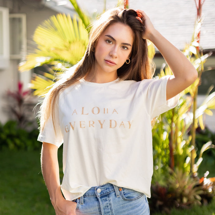 Can you really ever have enough comfy tees? We don't think so. Our white tees are made with organic cotton. Featuring a hand stamped lettering unique to each tee. This shirt is completely plant based and safe on your skin and our planet. This tee comes pre-cut at the hem for the perfect length, hitting right at your waistline. Pre-washed for ultimate comfort and added softness.  Hand Stamped  Perfect for high-waisted bottoms, can be tucked in  Raw Hemline, Relaxed Fit  Model is wearing size medium