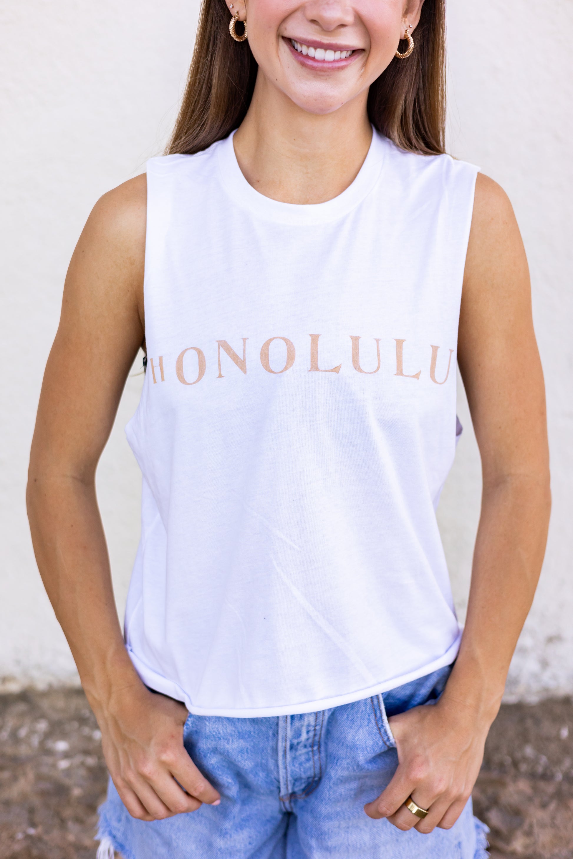 This tank is made with organic cotton. Featuring a hand stamped lettering unique to each tee. This tank is completely plant based and safe on your skin and our planet. This tank comes pre-cut at the hem for the perfect length, hitting right at your waistline. For ultimate comfort and added softness this tank gets better with each wear.  Hand Stamped  Slightly Cropped - Perfect for high-waisted bottoms, also can be tucked in  Raw Hemline, Relaxed Fit  Model is wearing size medium