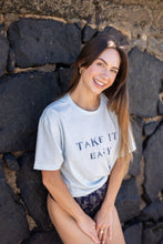 Can you really ever have enough comfy tees? We don't think so. Our white tees are made with organic cotton. Featuring a hand stamped lettering unique to each tee. This shirt is completely plant based and safe on your skin and our planet. This tee comes pre-cut at the hem for the perfect length, hitting right at your waistline. Pre-washed for ultimate comfort and added softness.  Hand Stamped  Perfect for high-waisted bottoms, can be tucked in  Raw Hemline, Relaxed Fit  Model is wearing size medium